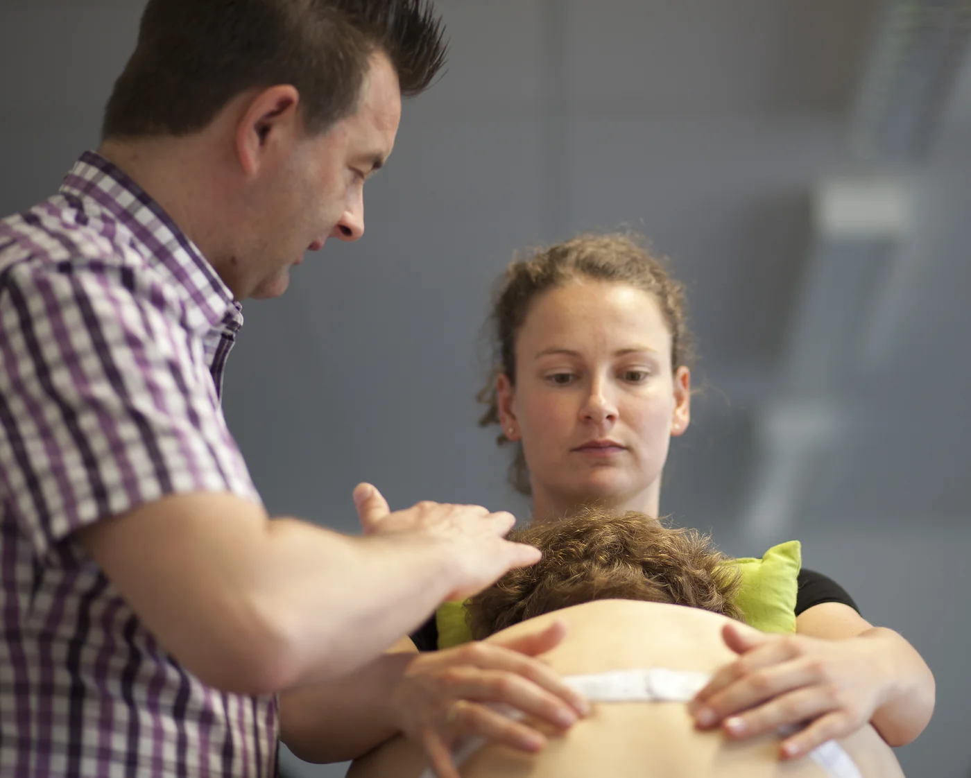Dozent leitet eine Studierende bei der Palpation an