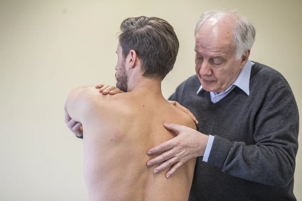 Palpation des Schulterblatts am stehenden Patienten